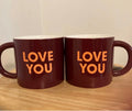 This is a maroon Room Essentials 16oz stoneware coffee mug with orange "LOVE YOU" text.