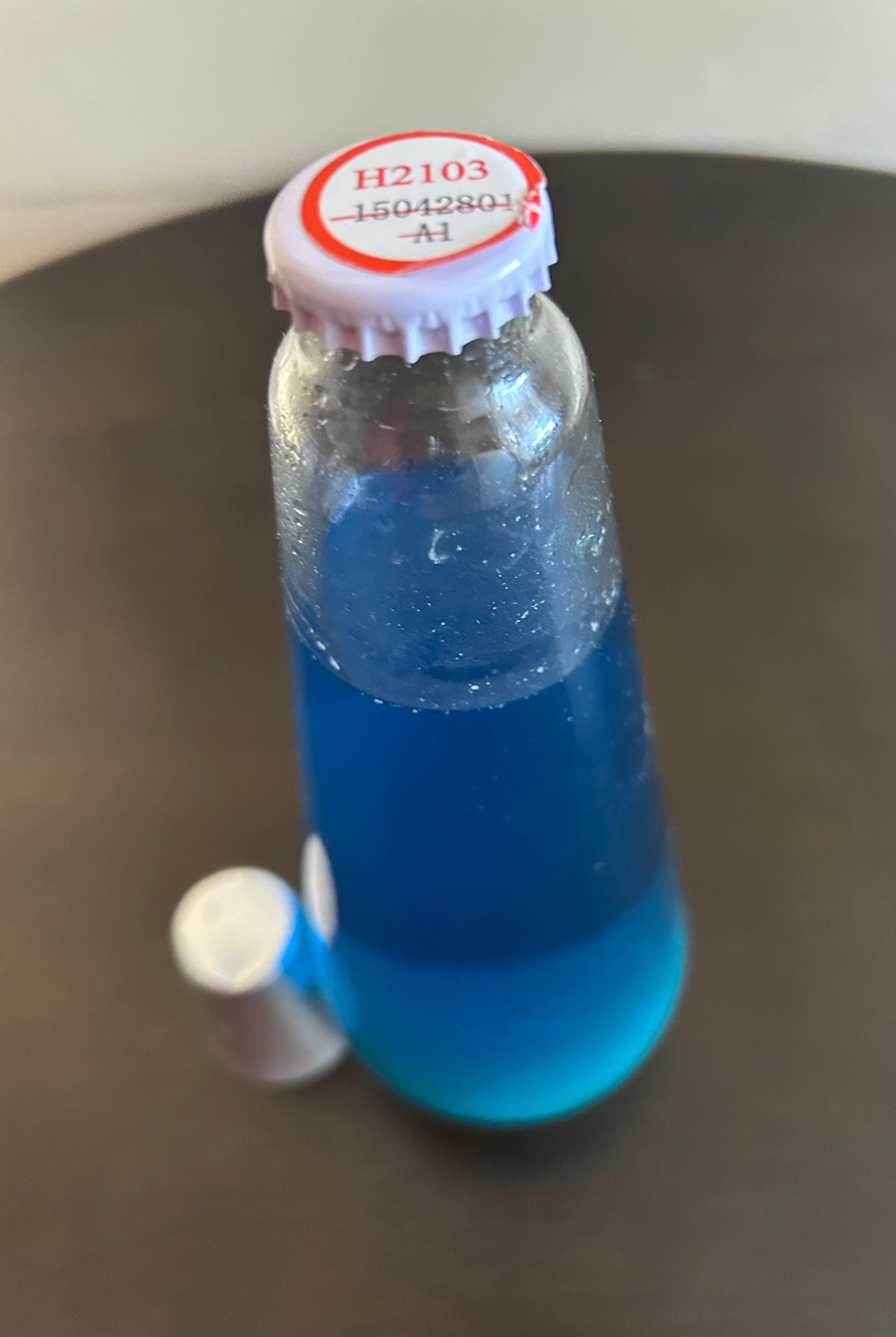 lava lamp replacement bottle, contains blue liquid. H2103