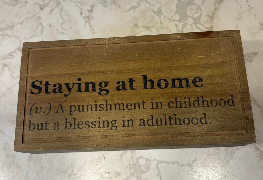 This is a natural wood keepsake box featuring a personalized engraved quote, “stay at home. A punishment in childhood but a blessing in adulthood.
