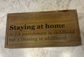 This is a natural wood keepsake box featuring a personalized engraved quote, “stay at home. A punishment in childhood but a blessing in adulthood.