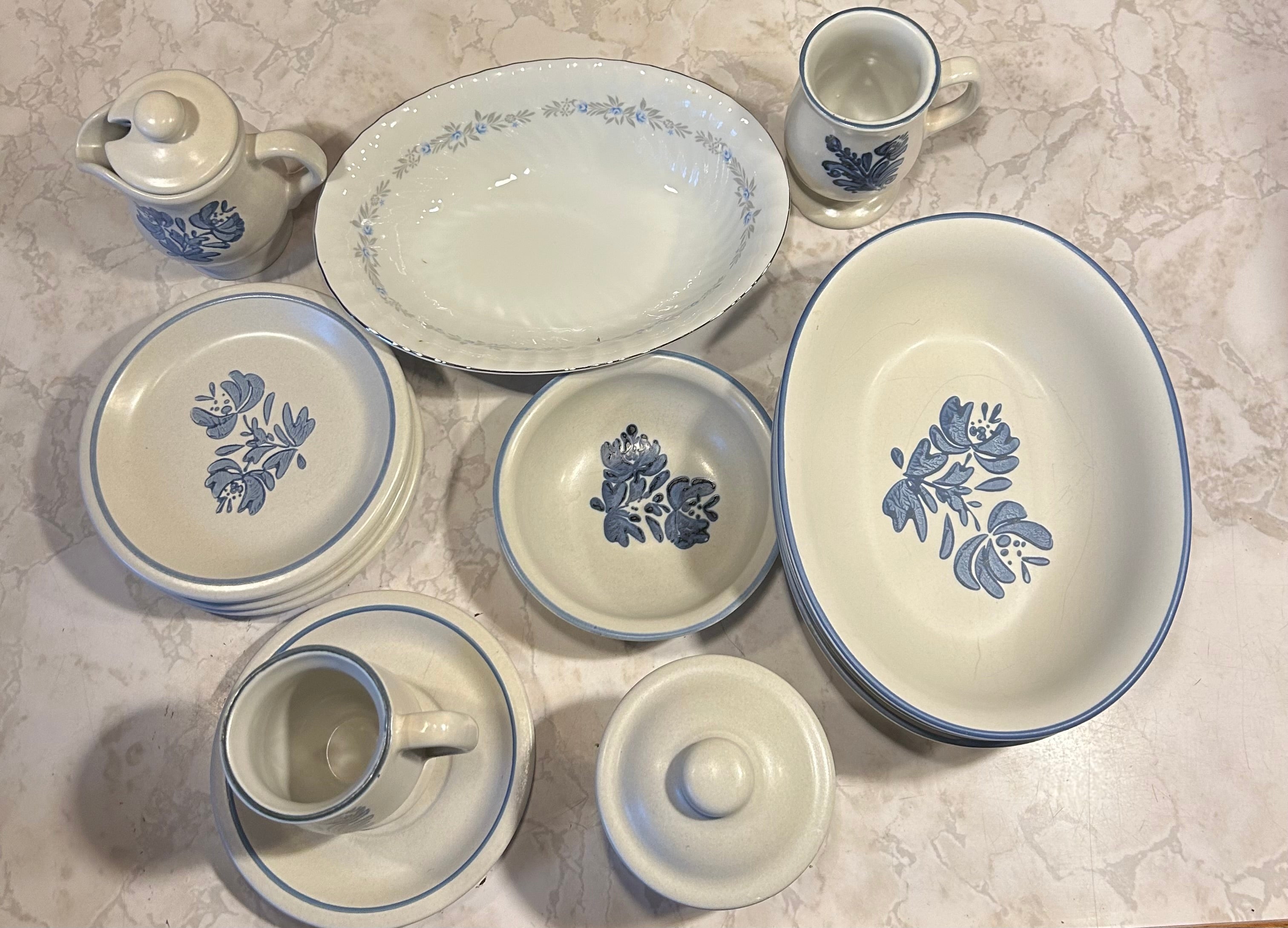 This is a set of vintage Pfaltzgraff Yorktowne stoneware dishes, featuring a gray base with a hand-painted cobalt blue floral pattern.