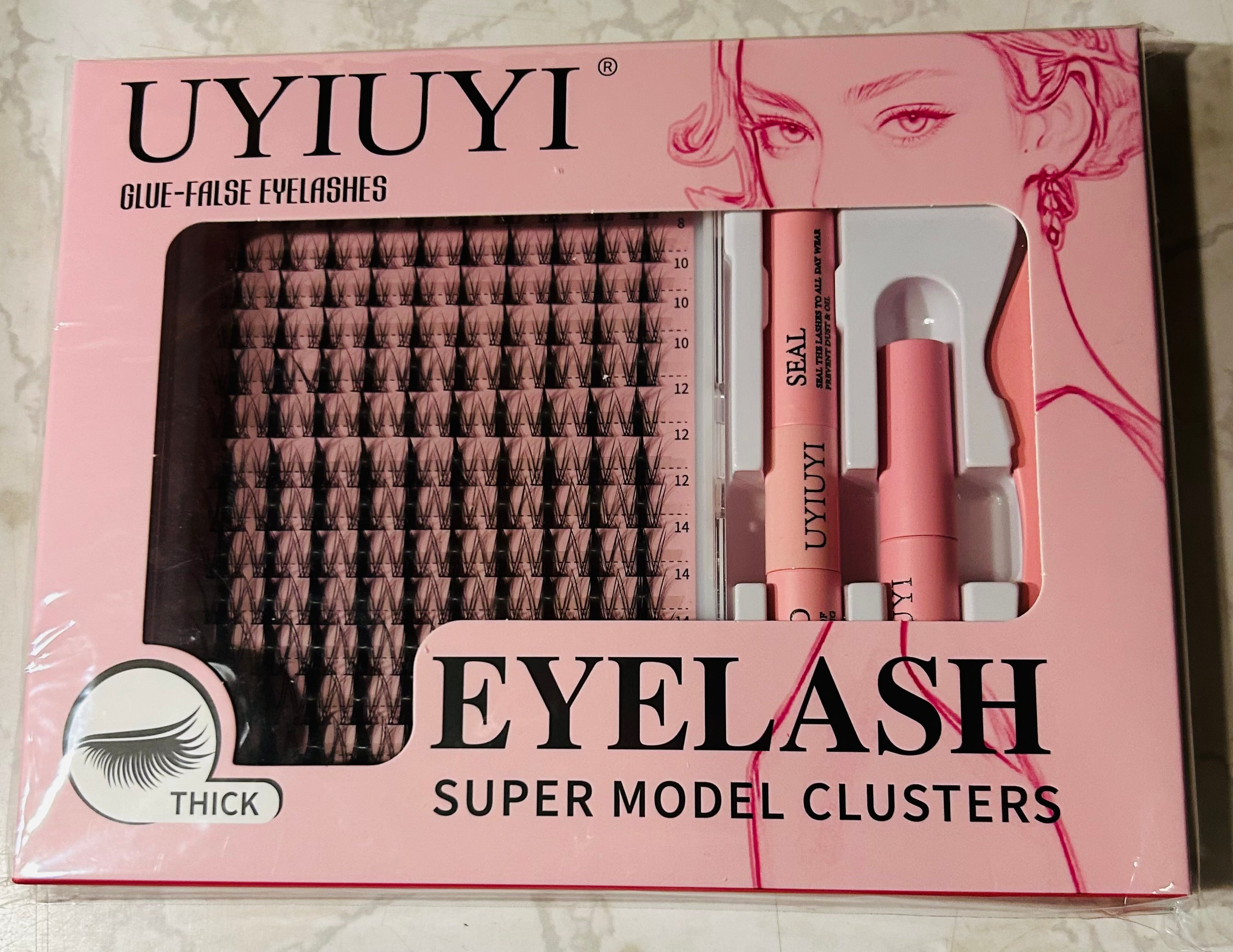 This is a UYIUYI false eyelash cluster kit featuring "Super Model Clusters" in a pink box.