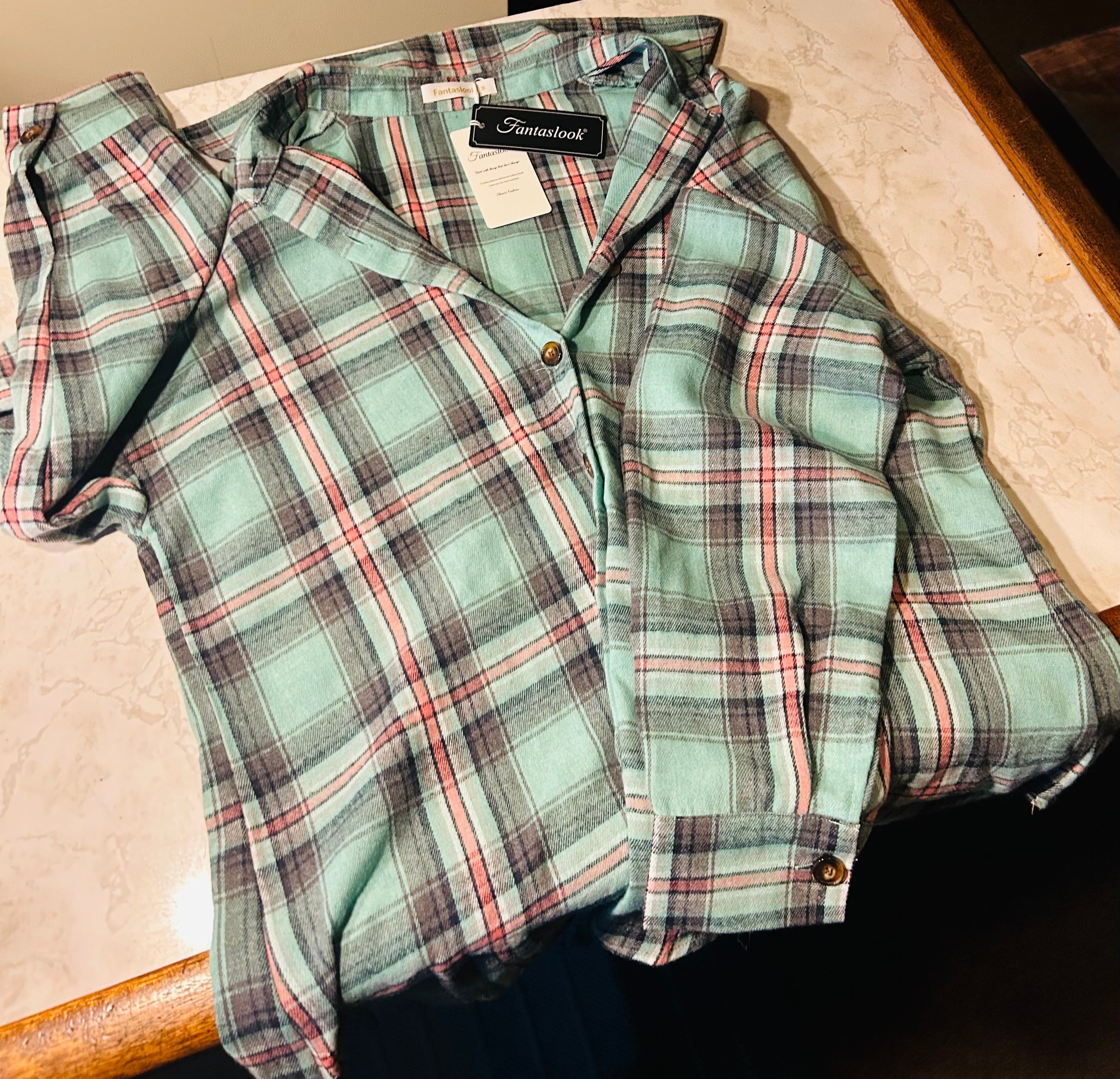 This is a new medium Fantaslook plaid flannel shirt for women featuring a relaxed, long-sleeve button-down design in aqua and pink tones
