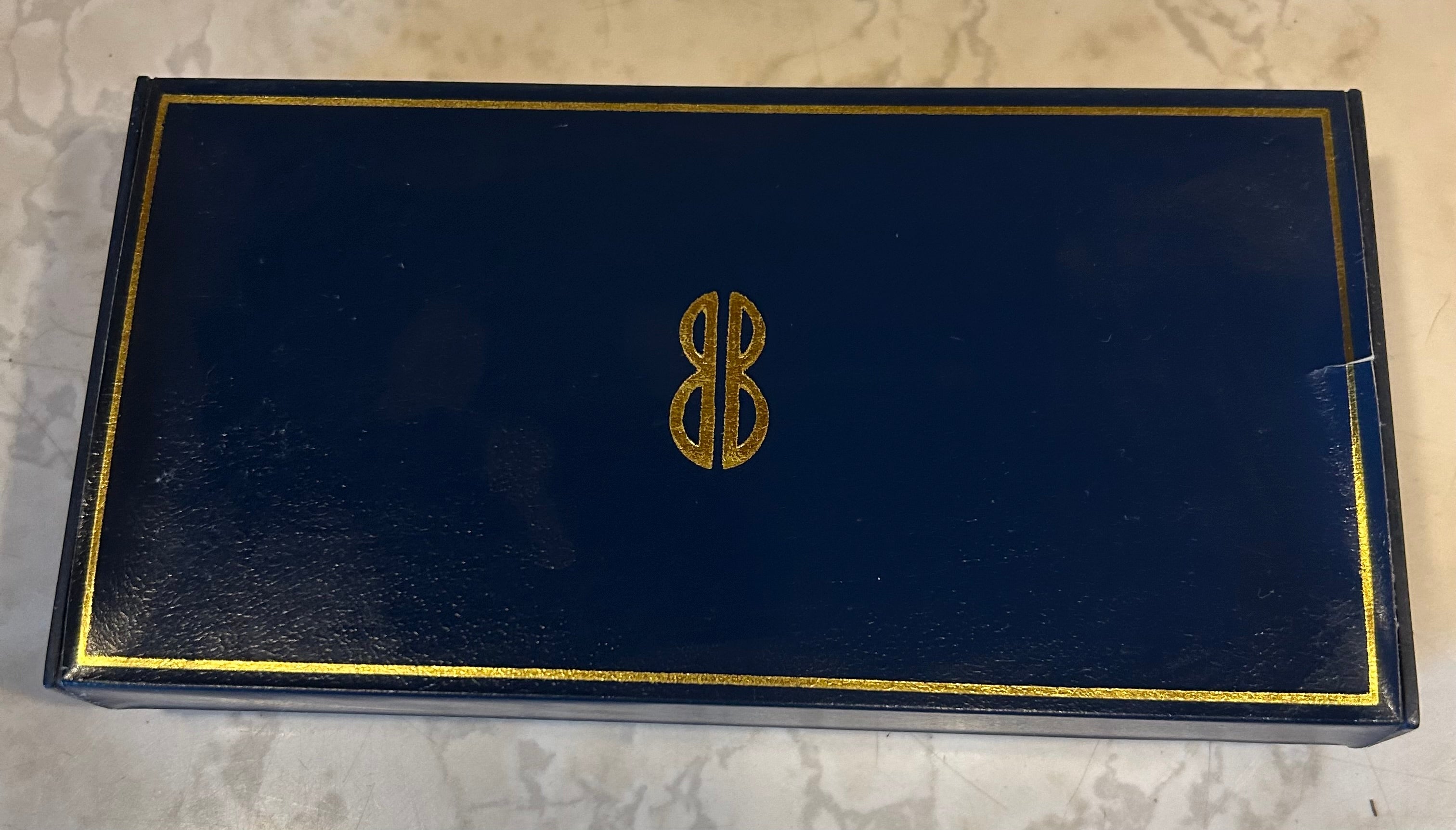 This is a Bill Blass black and chrome pen and pencil set, which includes a ballpoint pen, a rollerball pen, and a mechanical pencil.