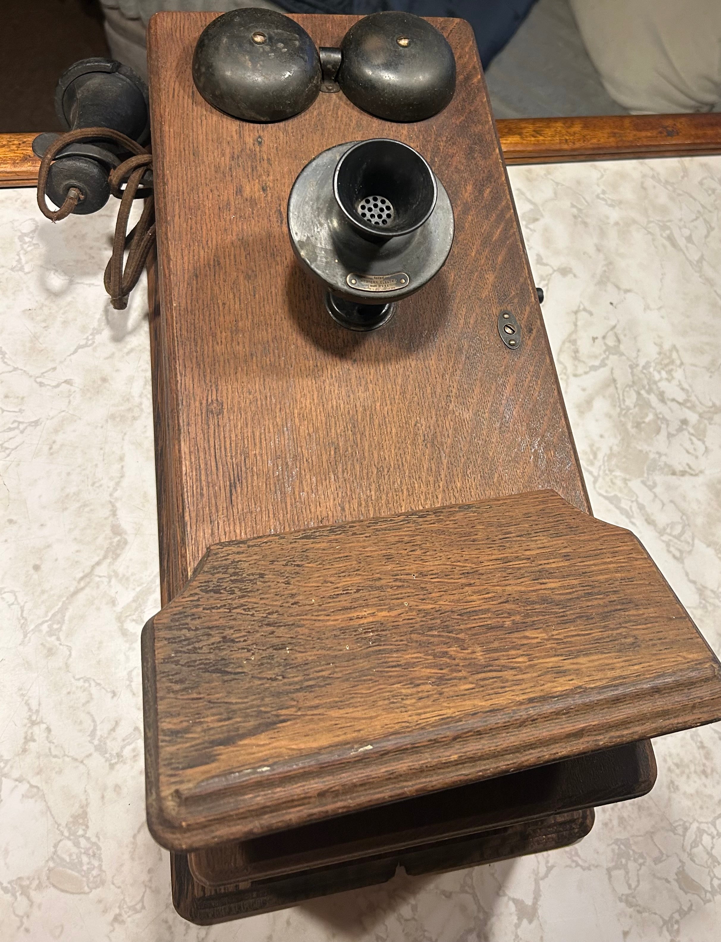 This is an antique wooden wall-mounted crank telephone, likely manufactured by companies such as Kellogg or Western Electric in the early 1900s.