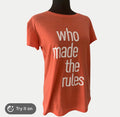This is a XL Reebok orange crew neck t-shirt featuring the white text "who made the rules".