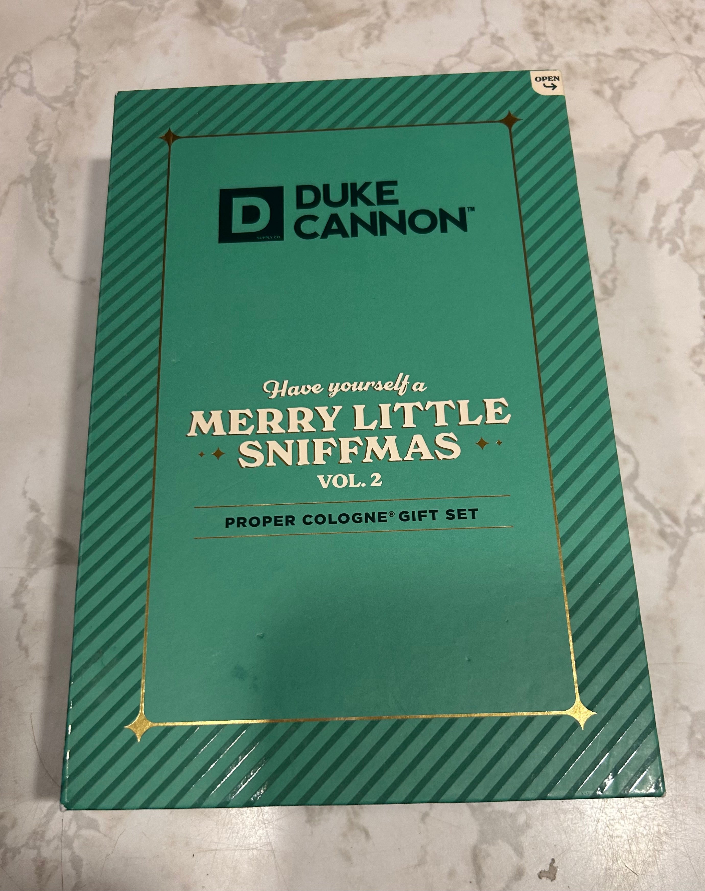This is a Duke Cannon Supply Co. "Merry Little Sniffmas" proper cologne travel spray gift set.
