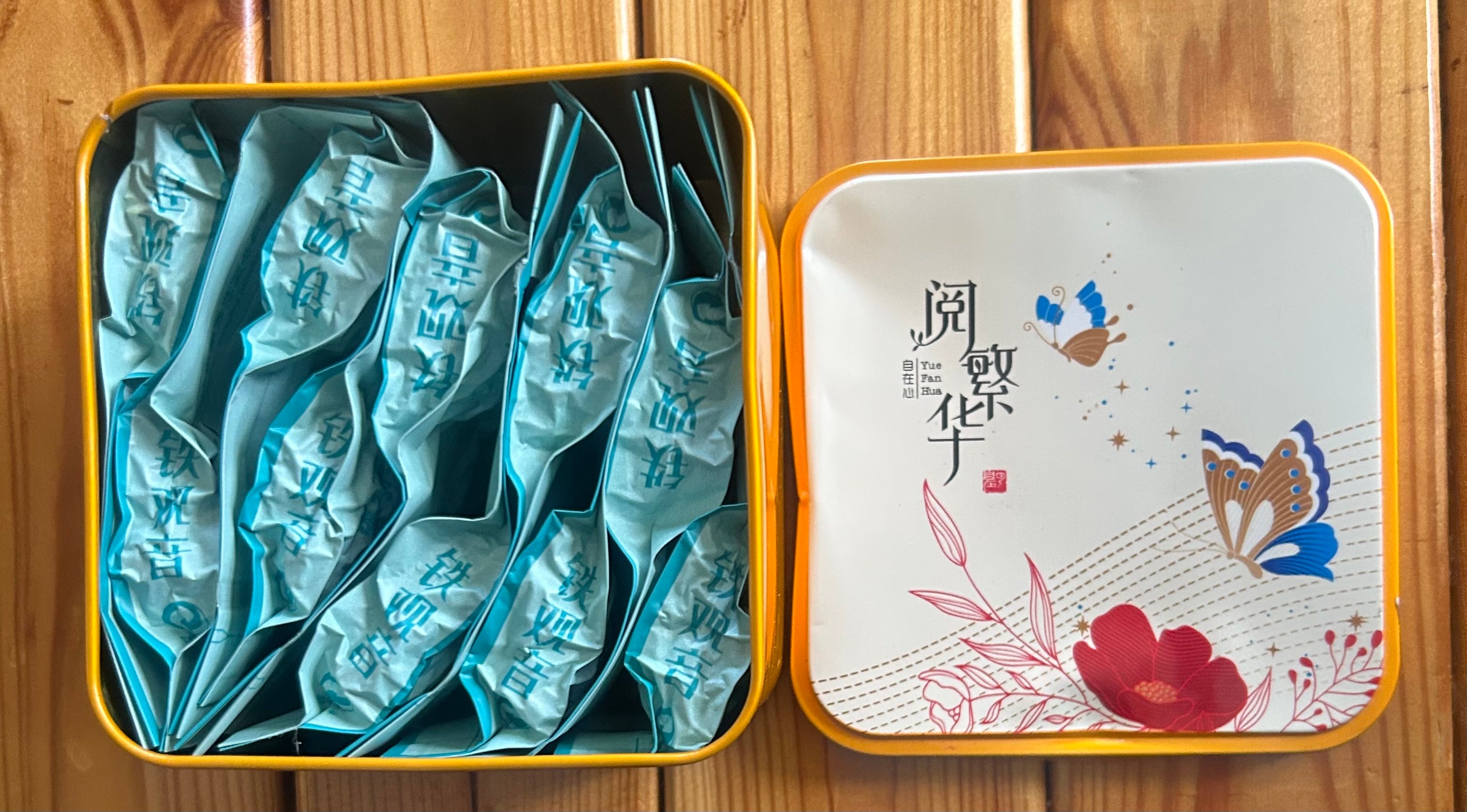 These are Hiwalk Tieguanyin Tea Egg Rolls packaged in a square yellow gift tin.