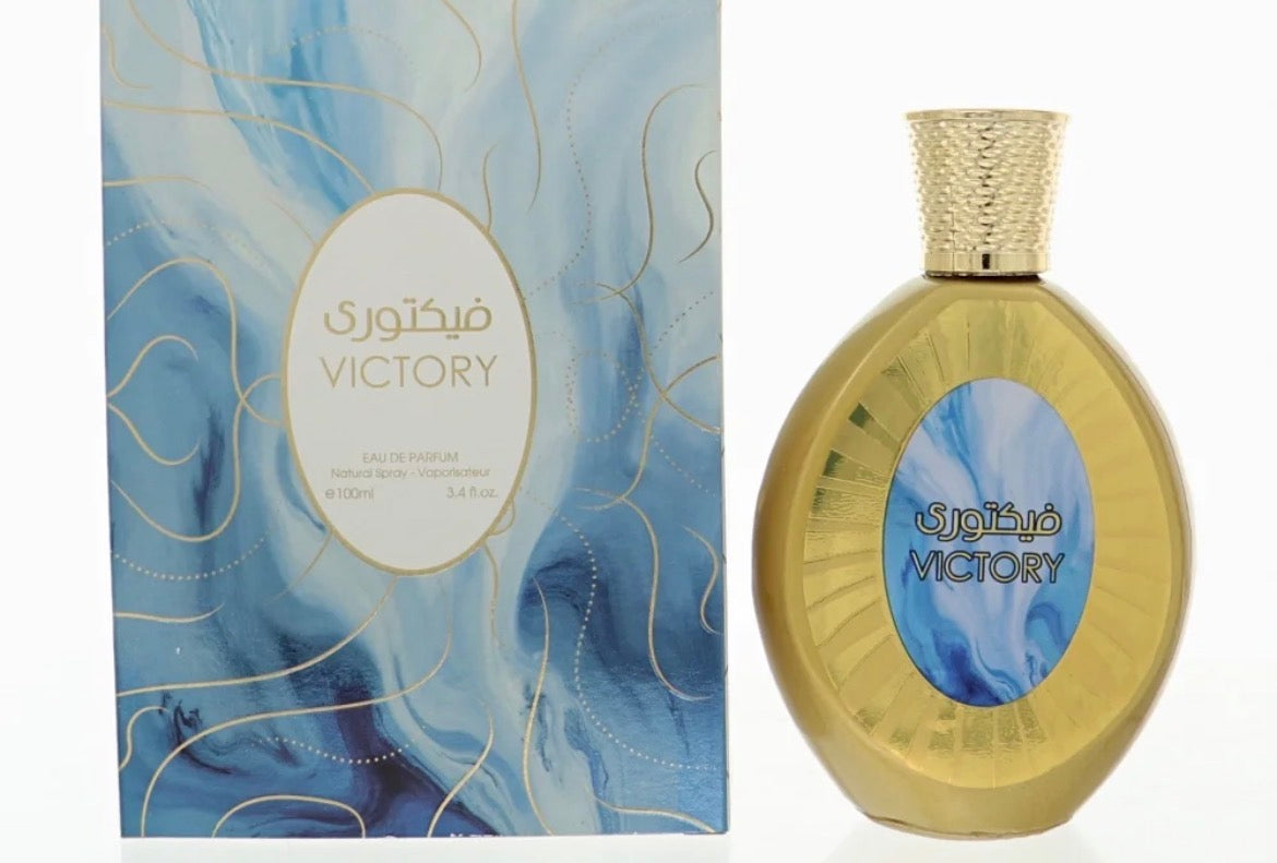 This is a bottle of Fragrance Couture Victory Eau de Parfum for women, featuring a blue and white marbled design with gold accents.