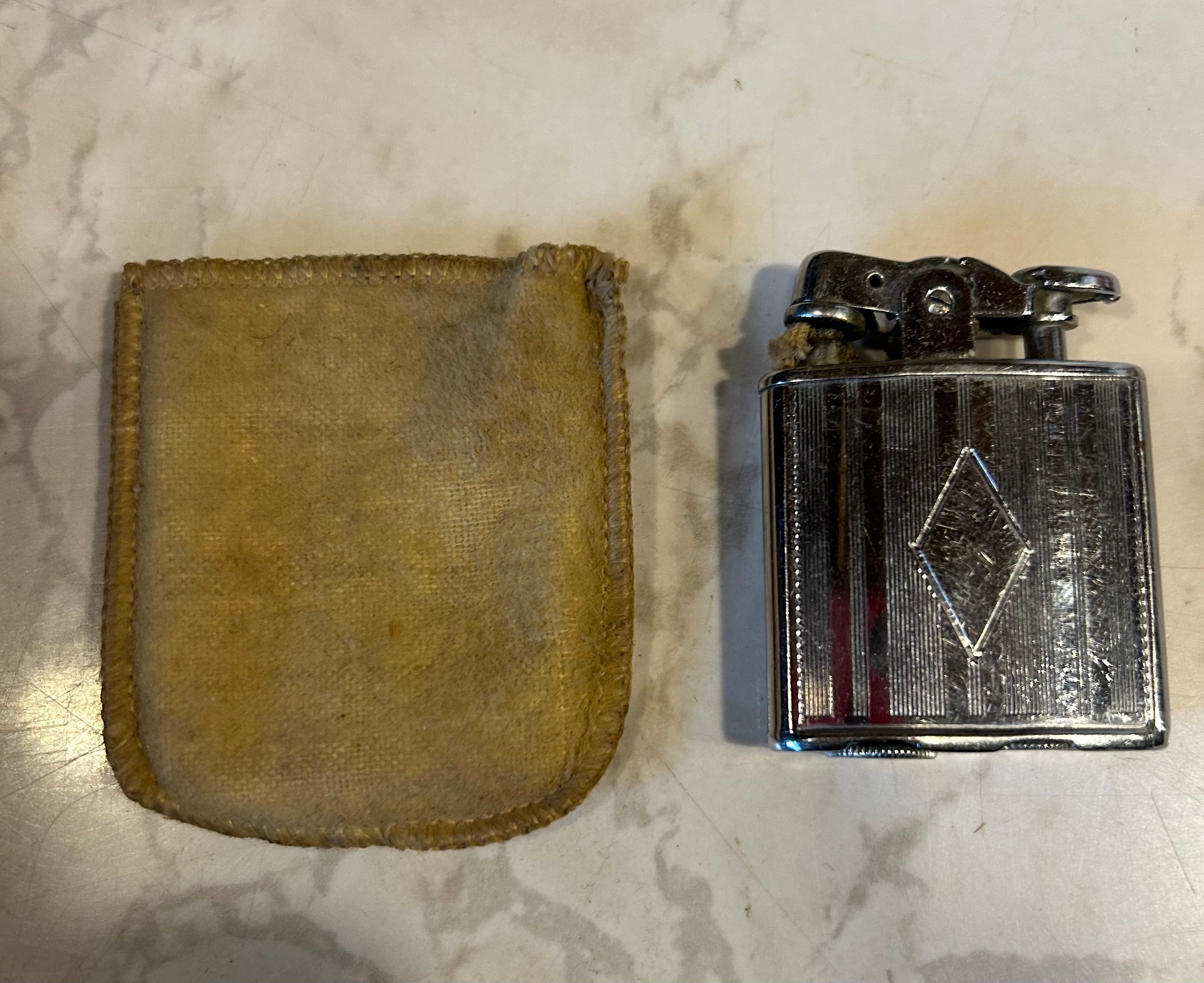 a vintage Ronson De-Light petrol pocket lighter, likely manufactured in the 1930s by the Ronson Art Metal Works company.