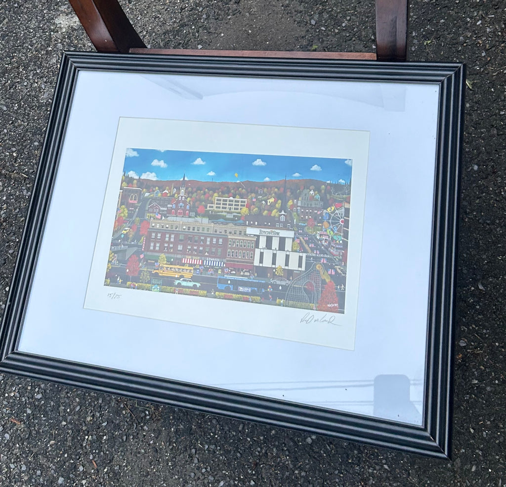 Original signed 15 of 25 “Home is Where The Heart Is" by artist Richard Haskins, featuring a whimsical New England town scene with colorful autumn foliage. “Downtown North Adams
