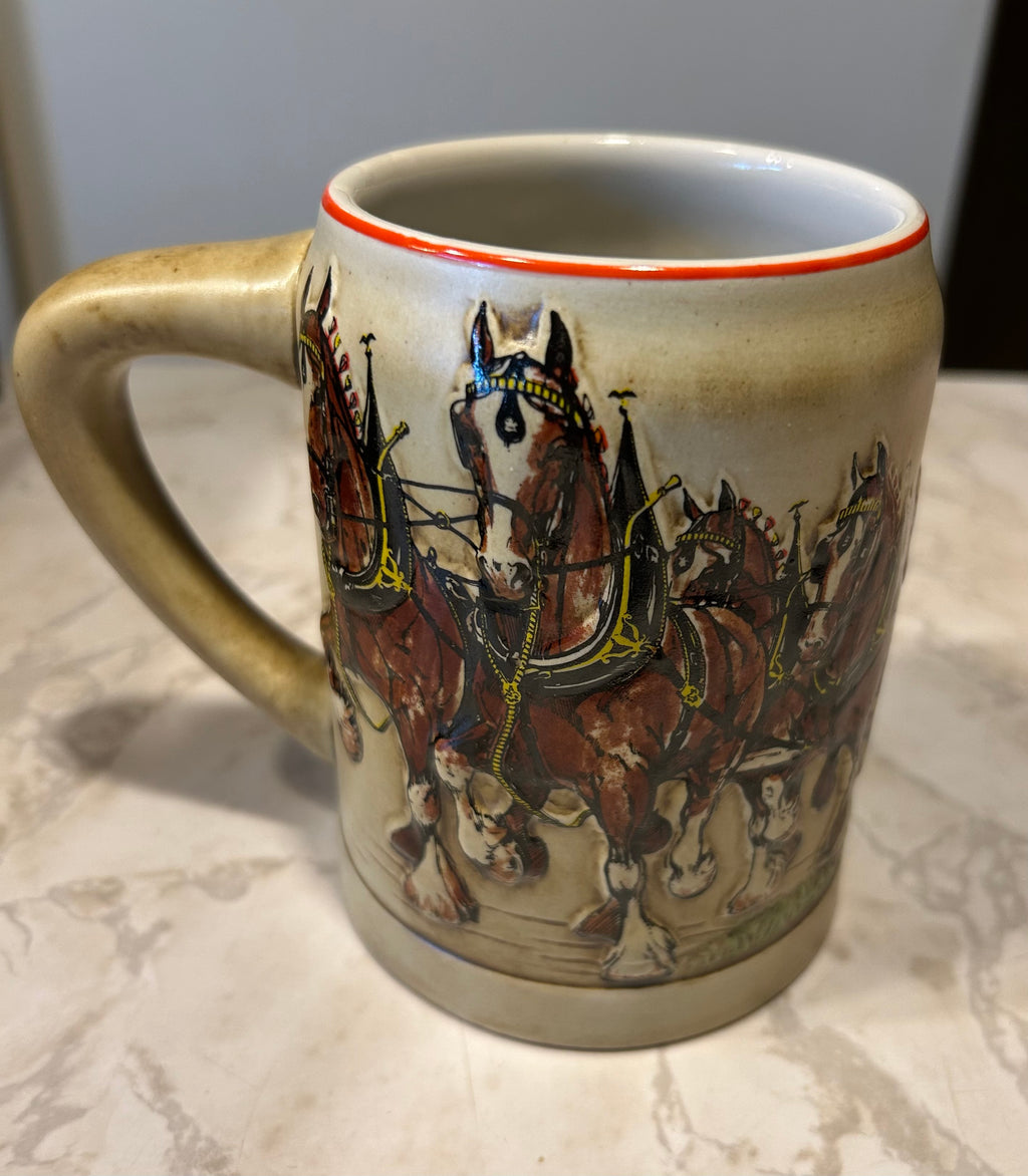 This is a 1980 Budweiser Champion Clydesdales Holiday ceramic mug produced by Ceramarte of Brazil.
