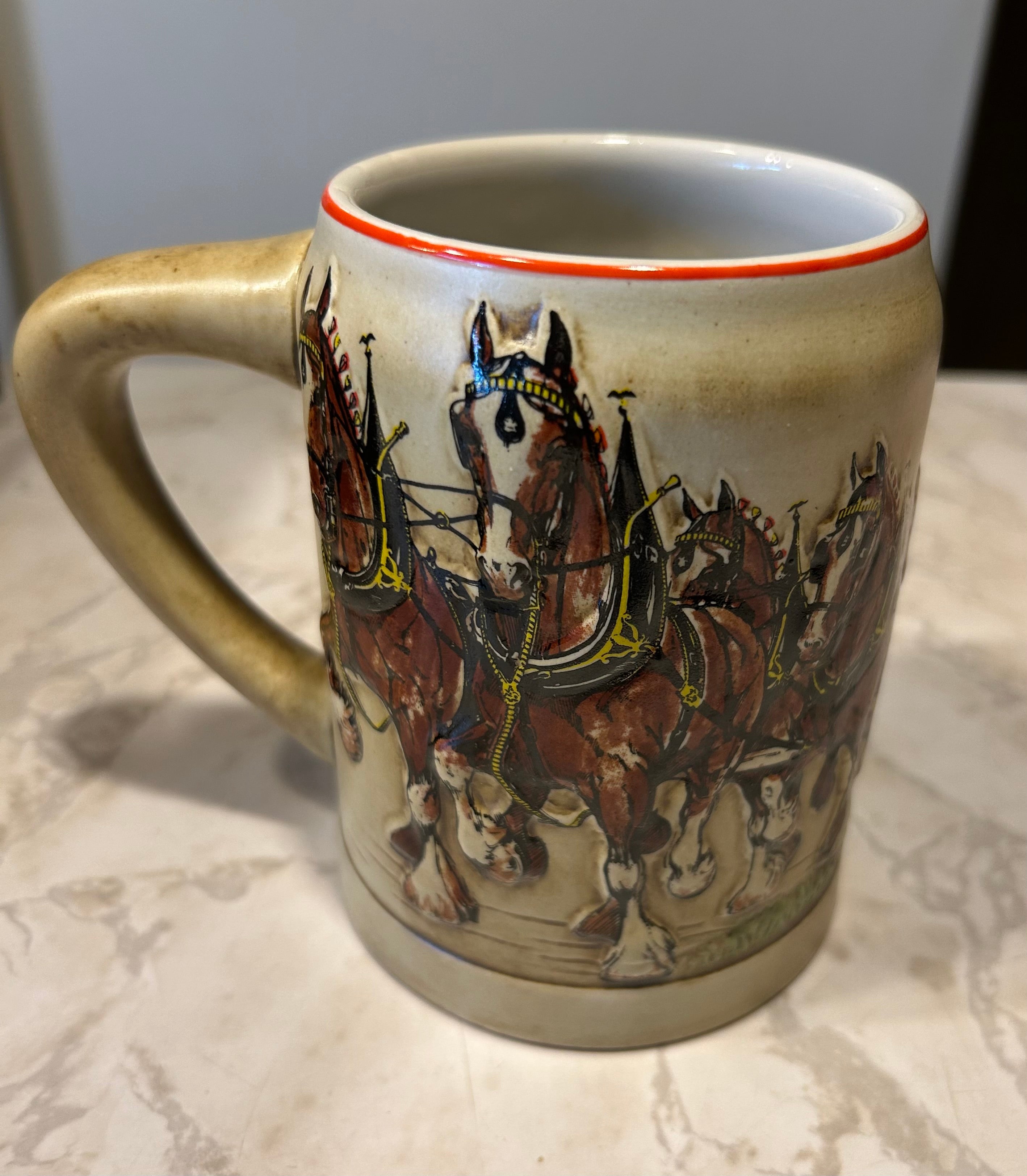 This is a 1980 Budweiser Champion Clydesdales Holiday ceramic mug produced by Ceramarte of Brazil.