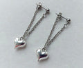 These are stainless steel puffy heart dangle chain earrings.