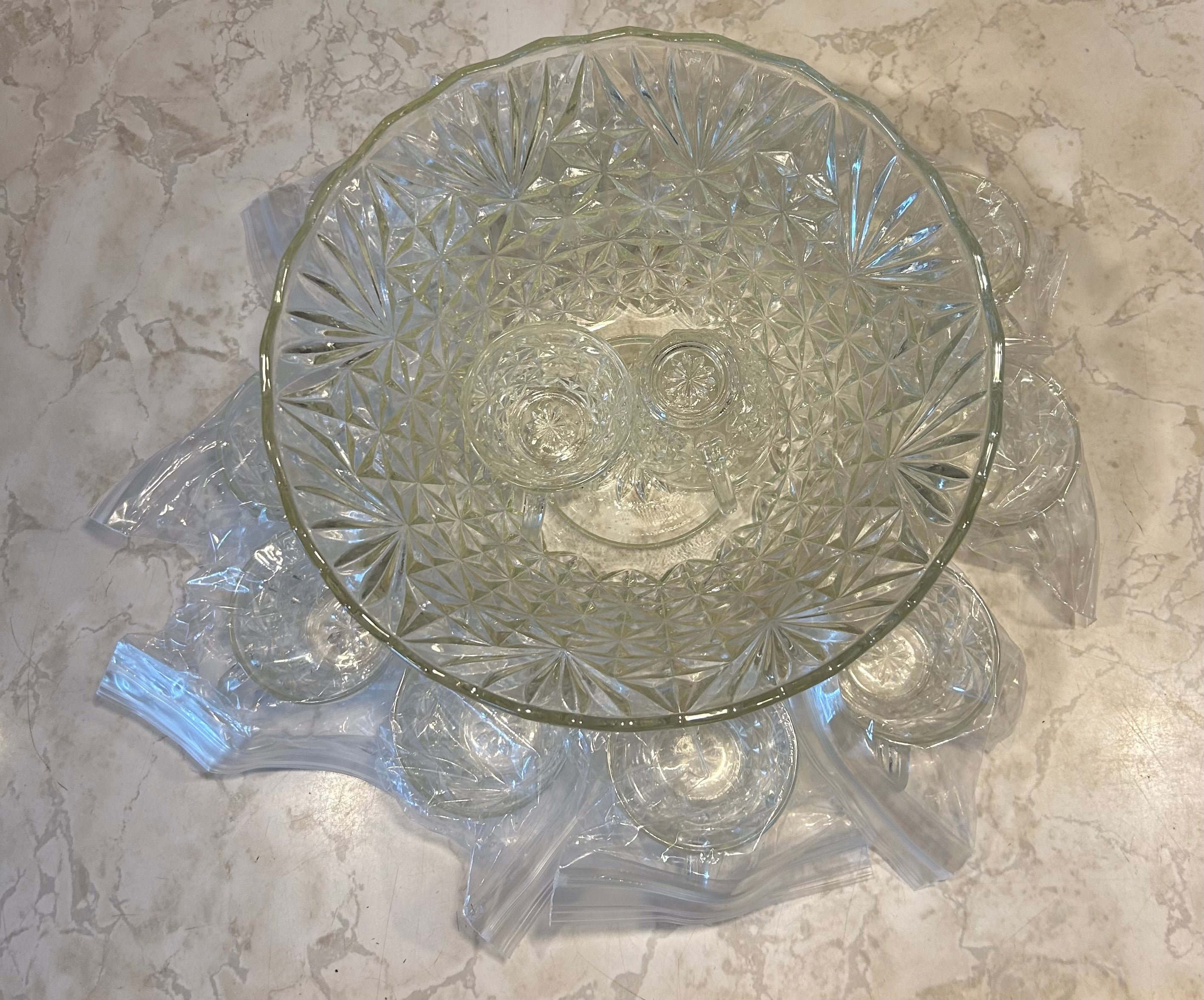 This is a vintage Anchor Hocking Arlington clear glass punch bowl set featuring a diamond and fan pattern and 11 glass fancy cups with set.