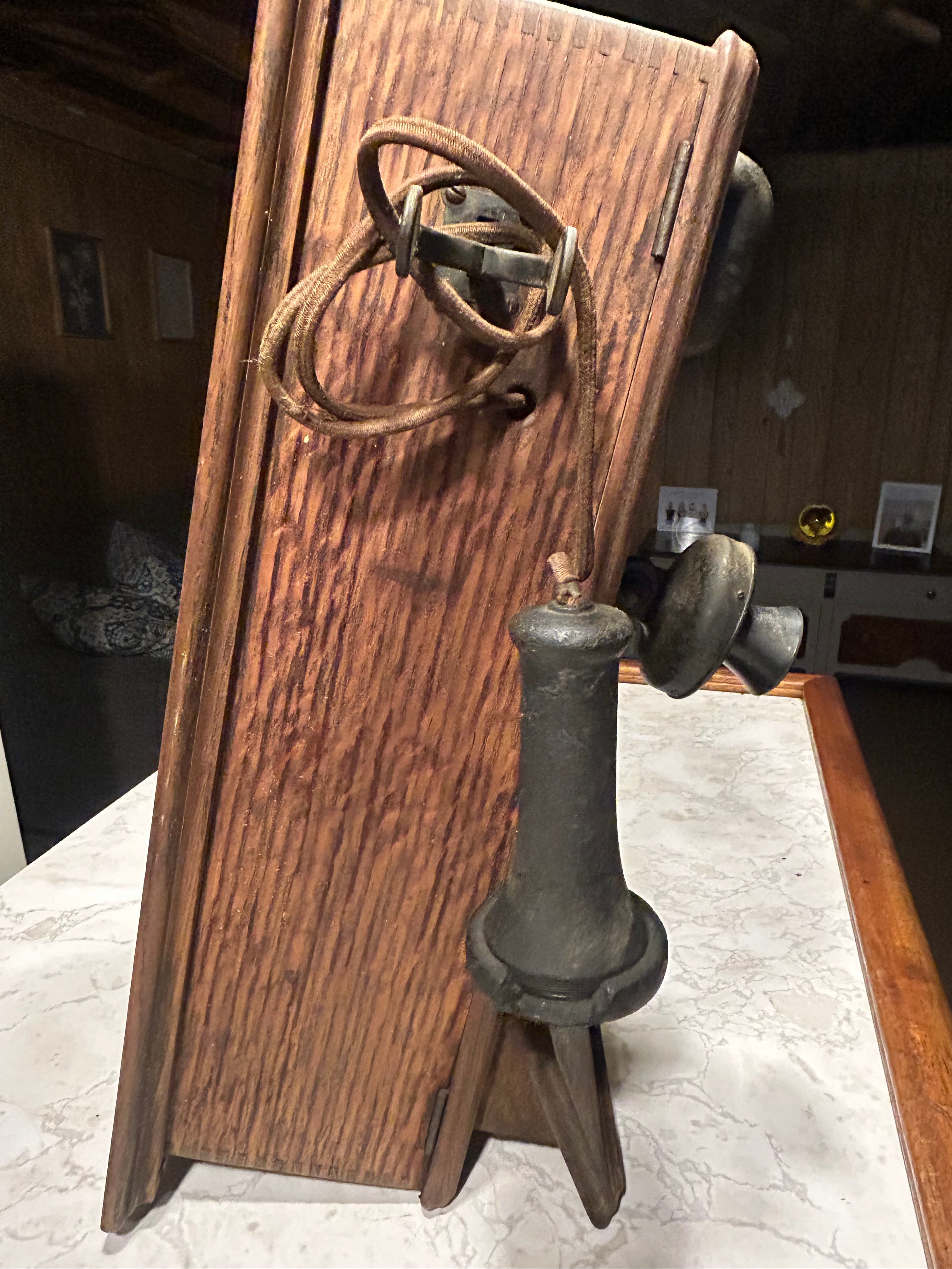 This is an antique wooden wall-mounted crank telephone, likely manufactured by companies such as Kellogg or Western Electric in the early 1900s.