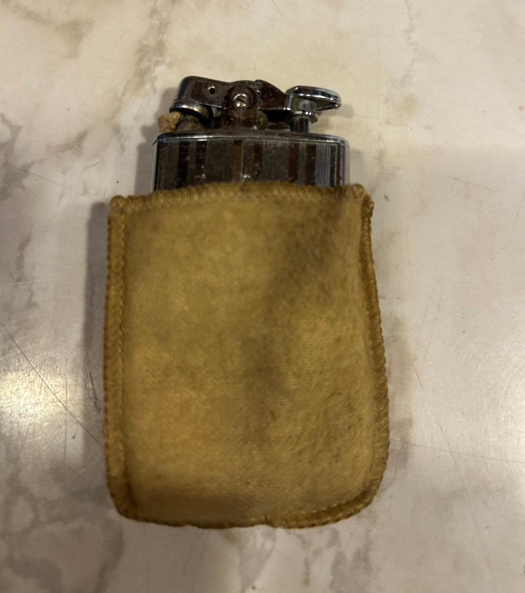 a vintage Ronson De-Light petrol pocket lighter, likely manufactured in the 1930s by the Ronson Art Metal Works company.