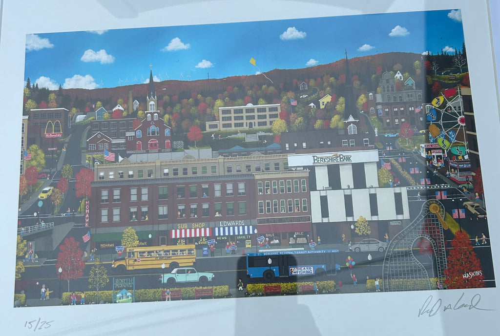 Original signed 15 of 25 “Home is Where The Heart Is" by artist Richard Haskins, featuring a whimsical New England town scene with colorful autumn foliage. “Downtown North Adams