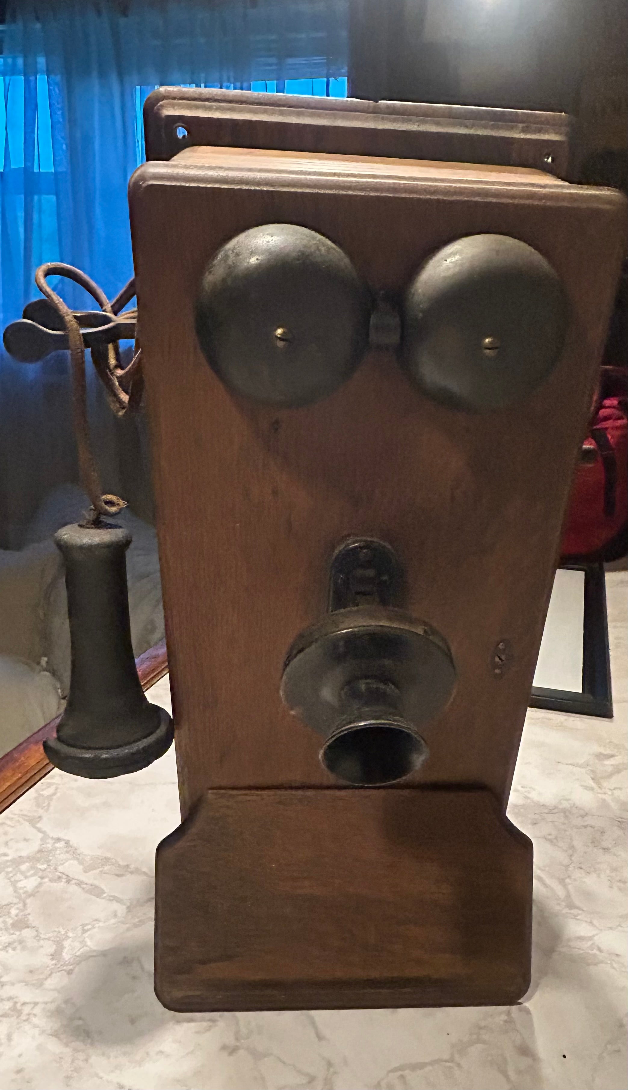 This is an antique wooden wall-mounted crank telephone, likely manufactured by companies such as Kellogg or Western Electric in the early 1900s.