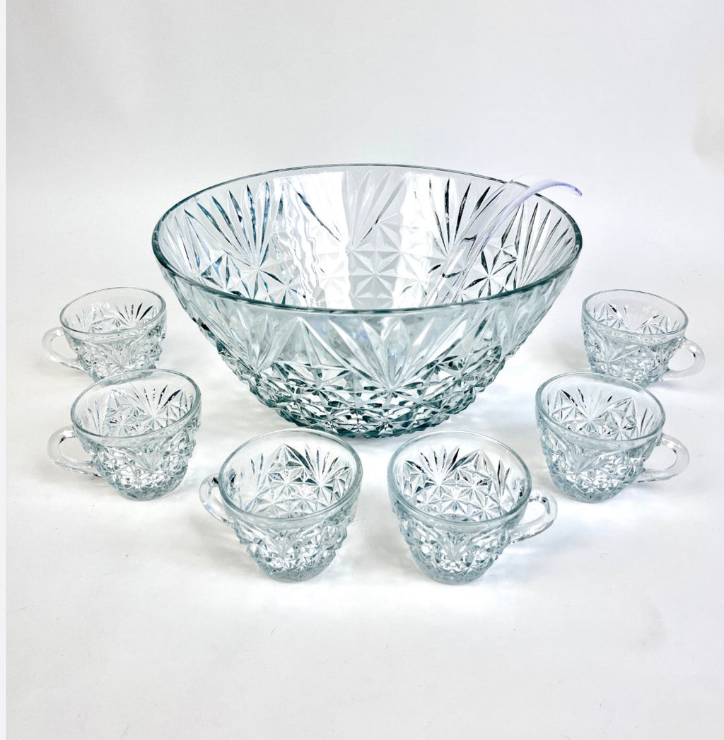 This is a vintage Anchor Hocking Arlington clear glass punch bowl set featuring a diamond and fan pattern and 11 glass fancy cups with set.