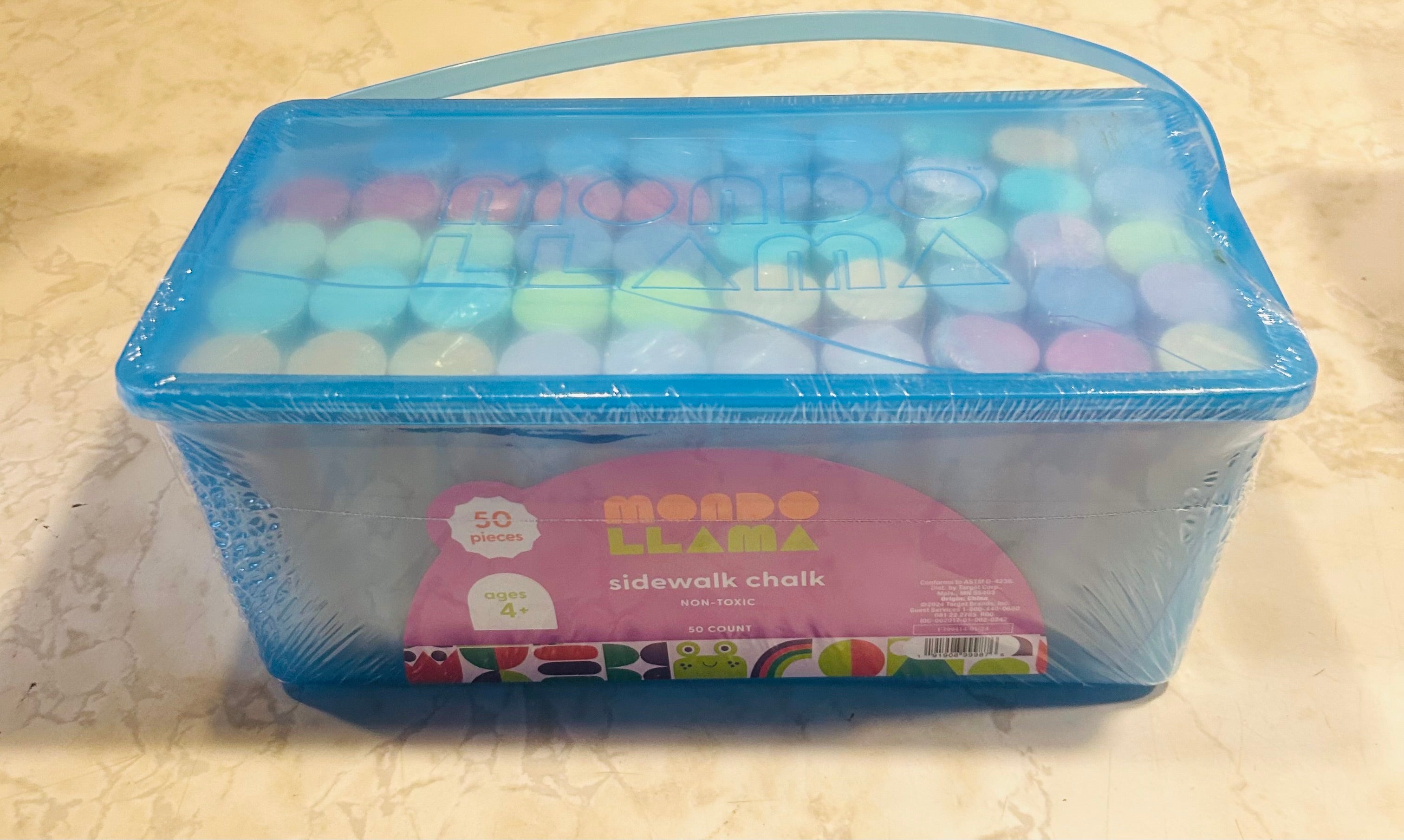 This is a Mondo Llama 50ct sidewalk chalk set in a blue container.