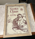 This is a vintage-style framed Christmas wall art print featuring a line drawing of Santa Claus.