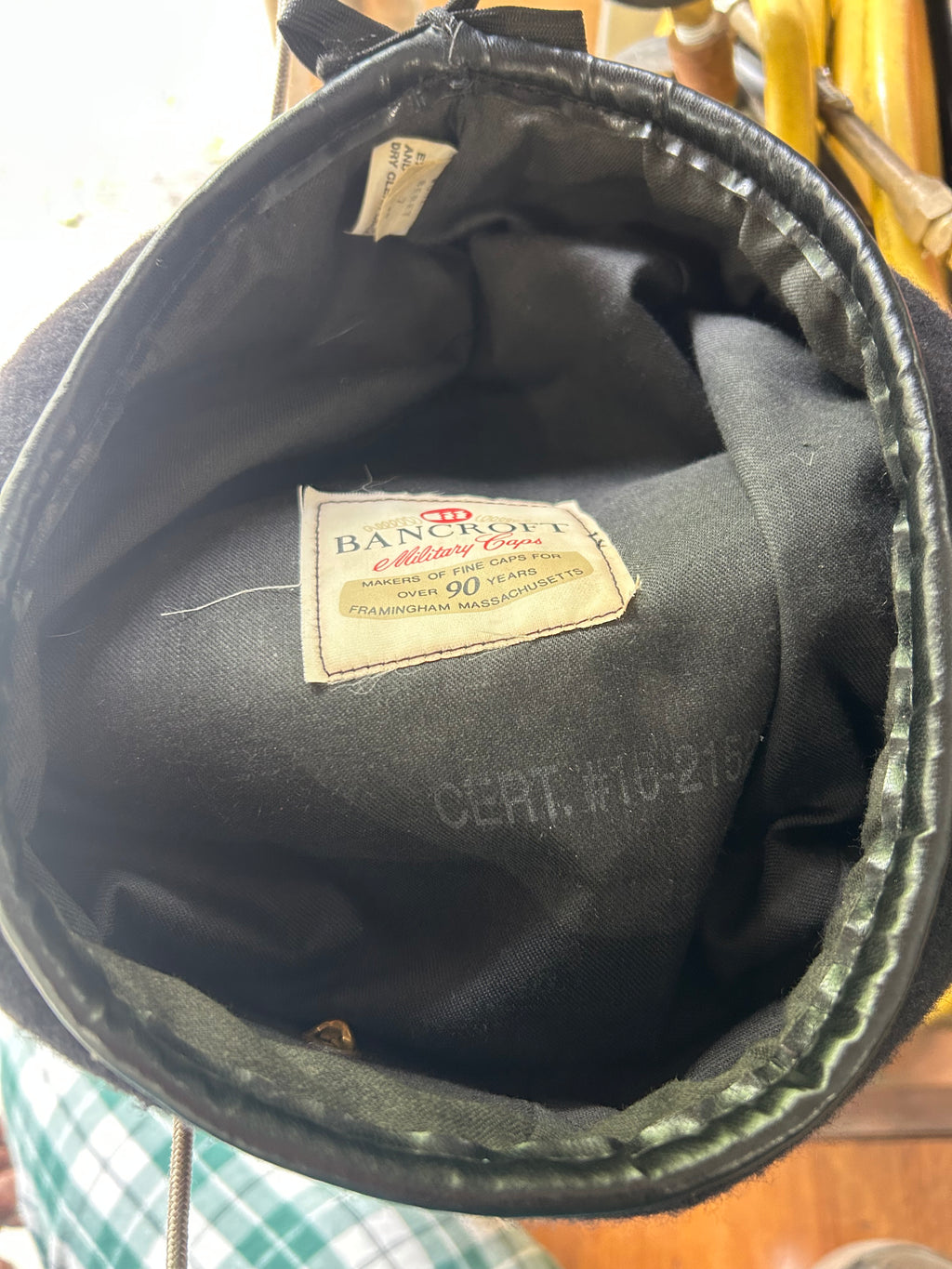 This is a vintage Bancroft Military Caps liner label indicating the item was made in Framingham, Massachusetts.