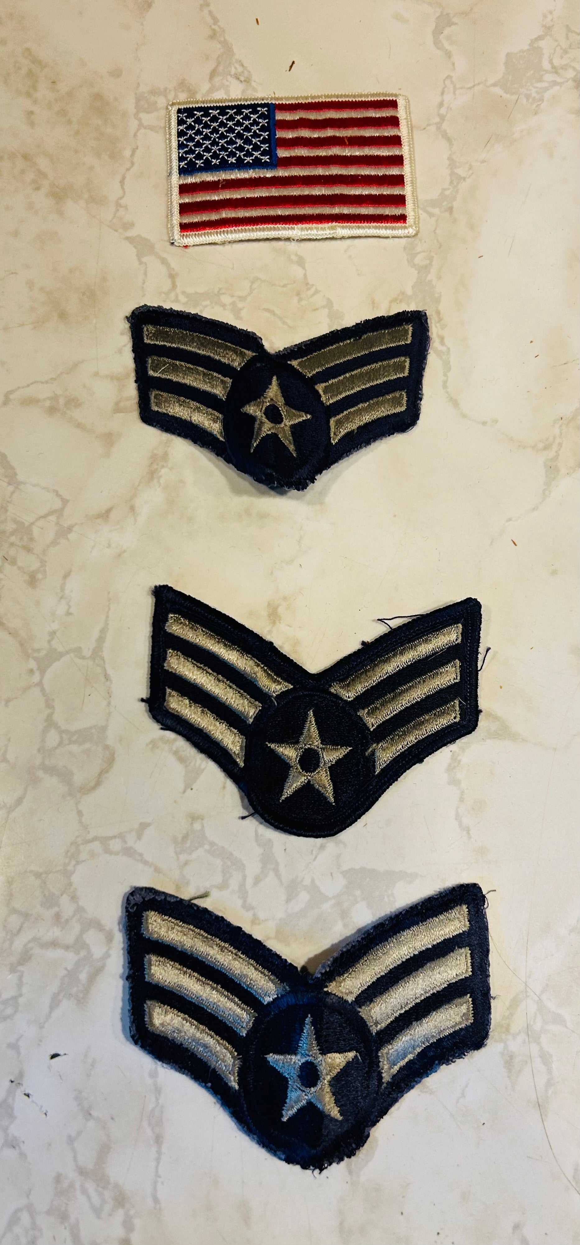 These are vintage real veteran souvenirs of U.S. Air Force Senior Airman chevrons, featuring three silver stripes with a star in the center.