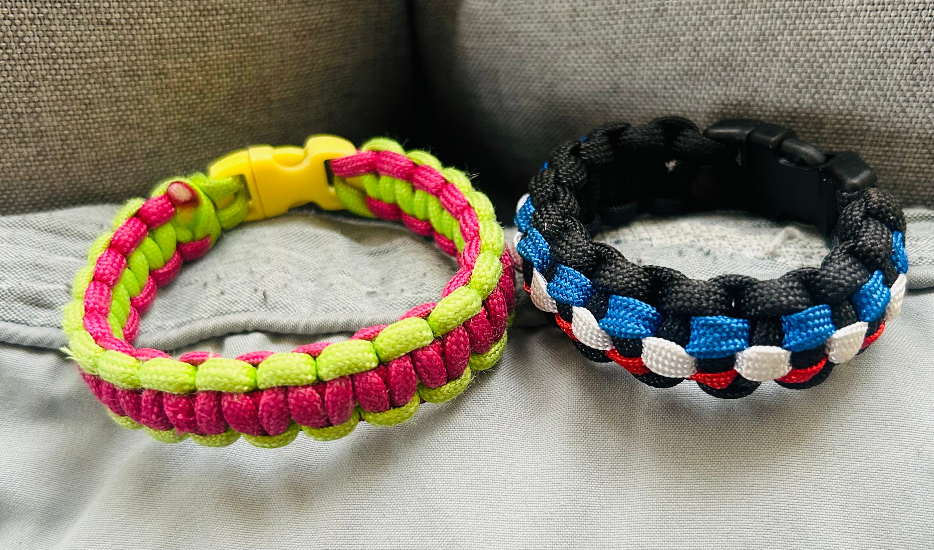 This is a handmade neon green and pink paracord bracelet with a matching buckle By Bear the artist.