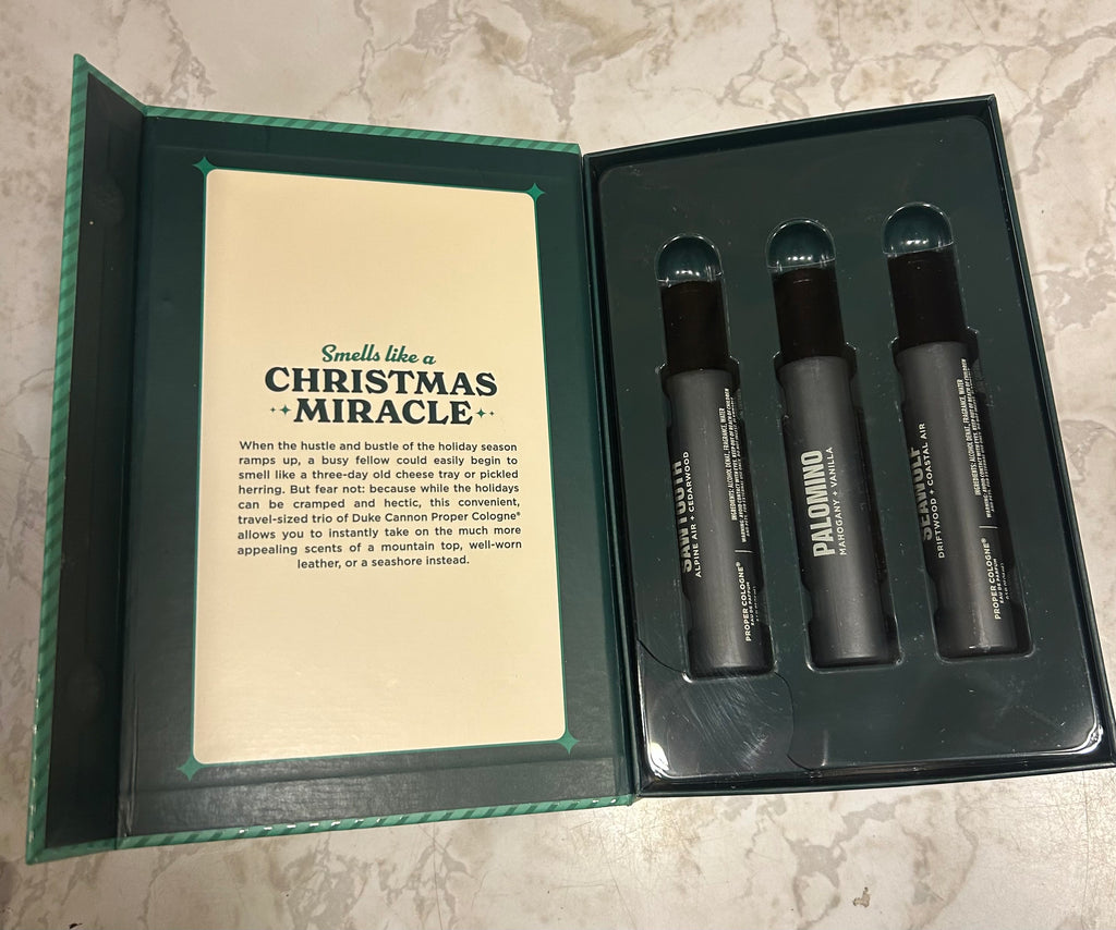 This is a Duke Cannon Supply Co. "Merry Little Sniffmas" proper cologne travel spray gift set.