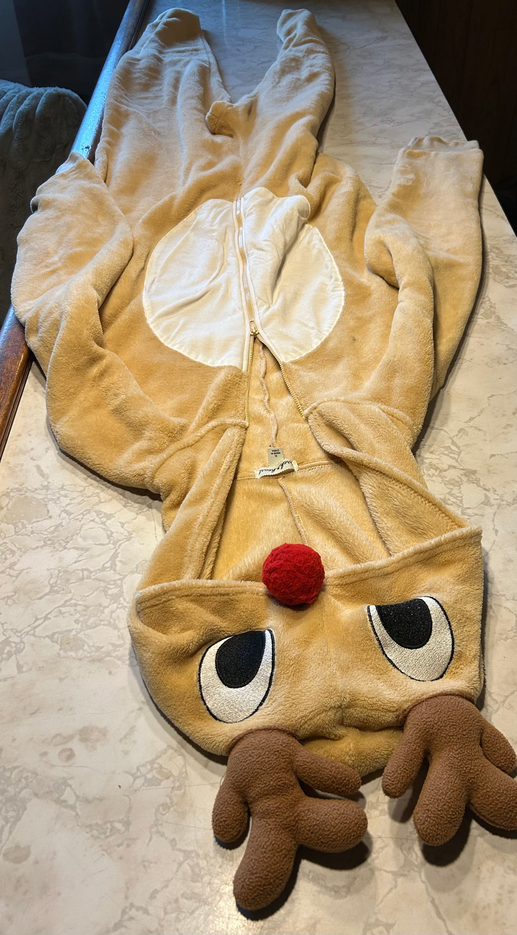 This is a derek & heart Rudolph the Red-Nosed Reindeer union suit onesie made of soft tan plush material.
