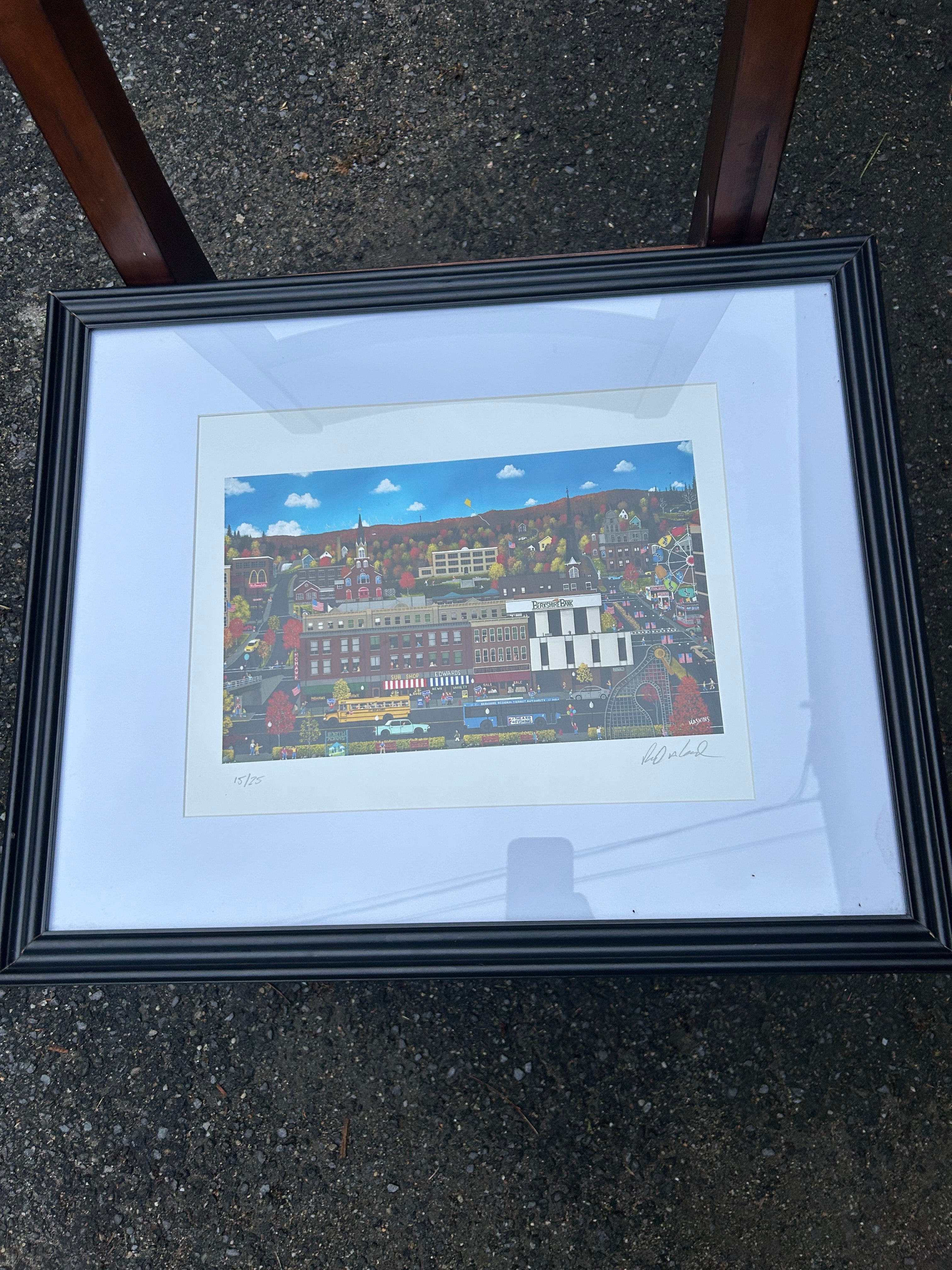 Original signed 15 of 25 “Home is Where The Heart Is" by artist Richard Haskins, featuring a whimsical New England town scene with colorful autumn foliage. “Downtown North Adams