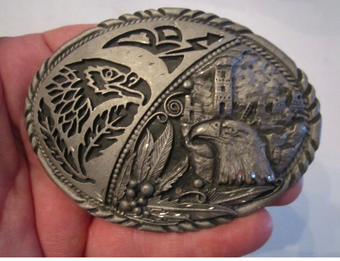 This is a vintage SSI pewter-colored belt buckle featuring a Southwestern or Native American eagle design.
