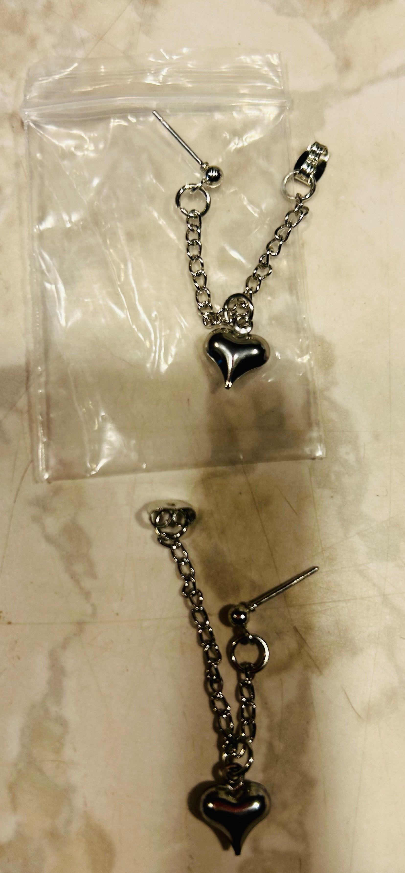 These are stainless steel puffy heart dangle chain earrings.