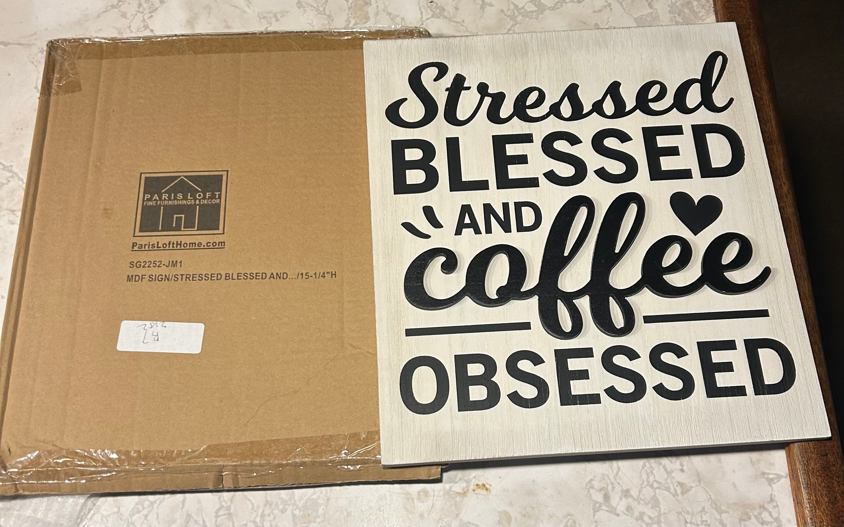 This is a white wall sign with black "Stressed Blessed and Coffee Obsessed" text on nice farm house wood.
