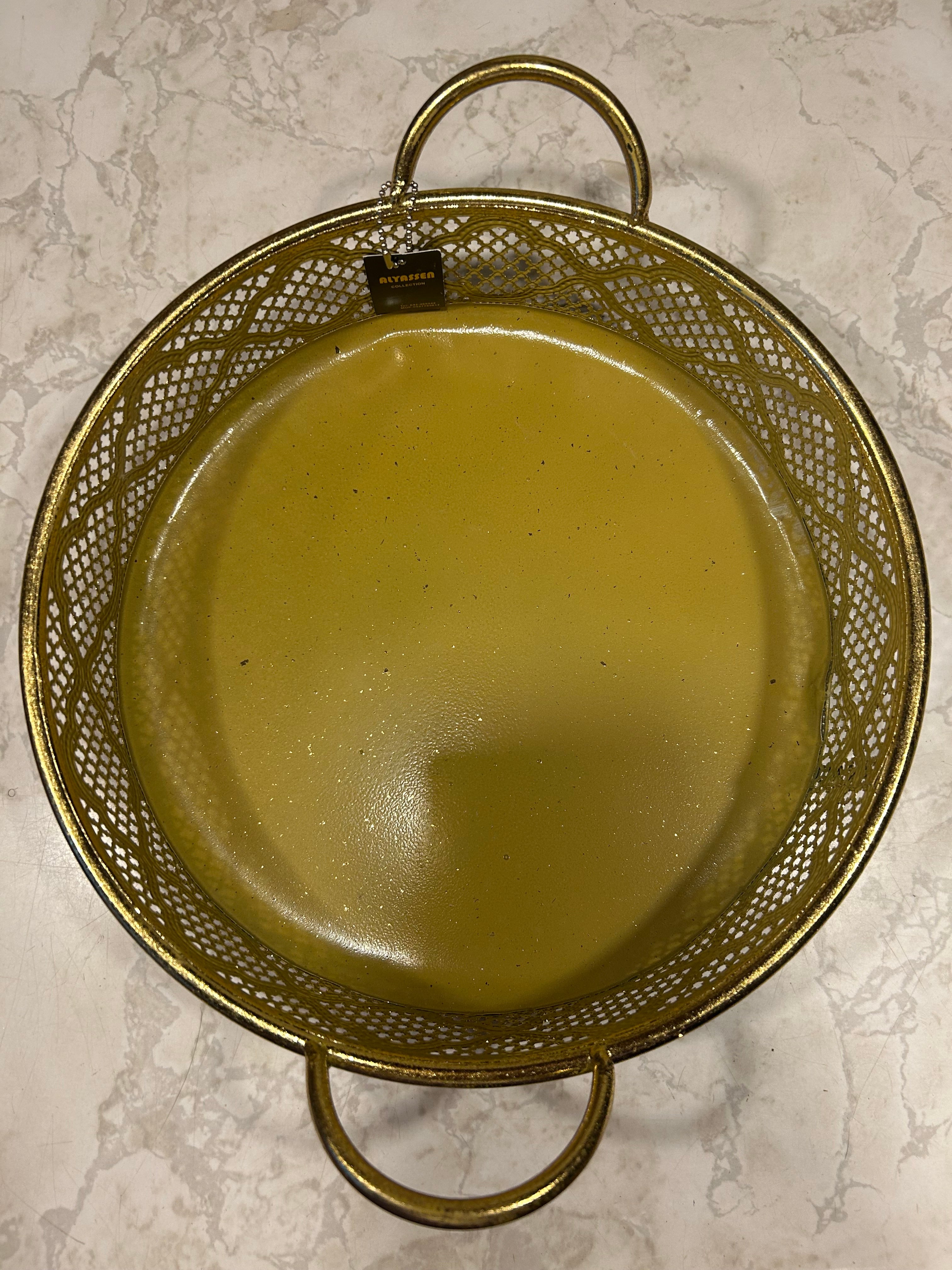 This Alyassen Collection golden decorative tray features a pierced metal filigree design and a handle.