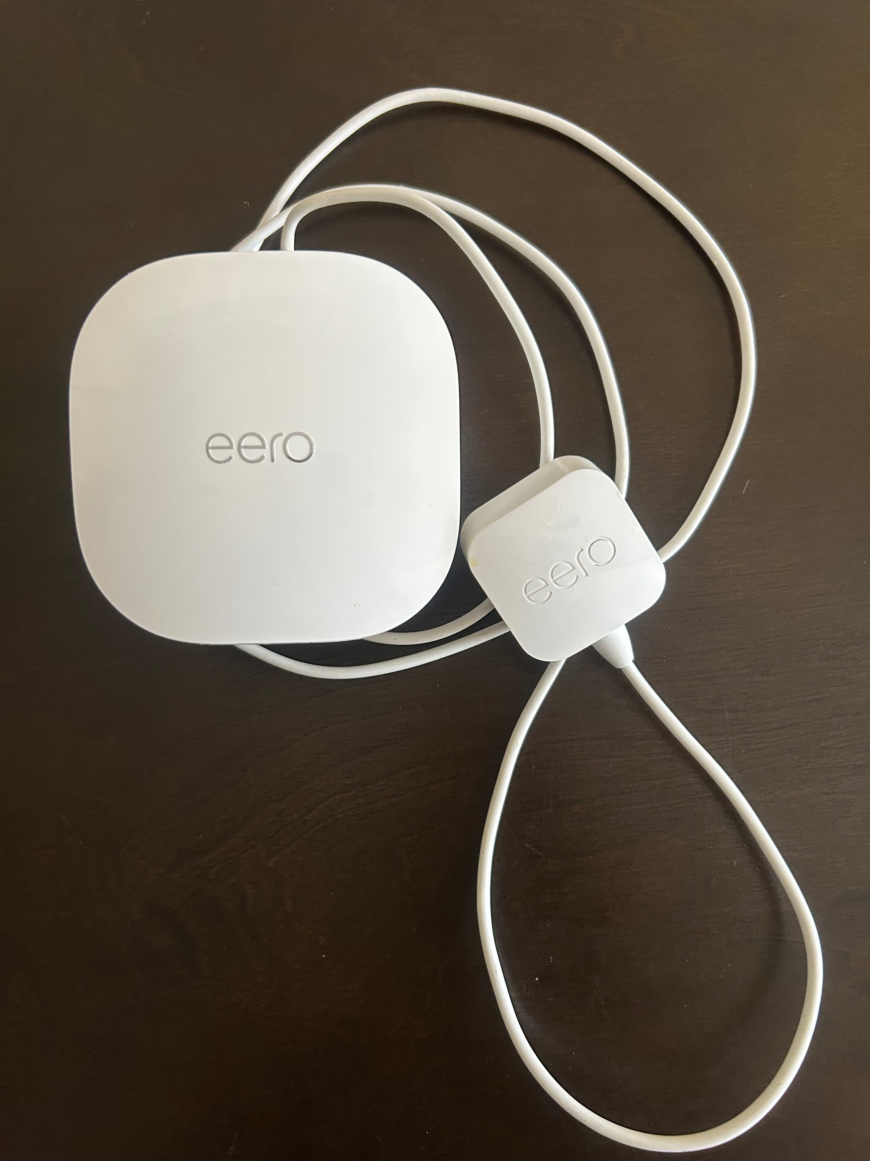 This is an eero Pro 6 mesh Wi-Fi 6 router featuring a compact, white, rounded-square design.It supports gigabit speeds and can connect 75+ devices to a network.