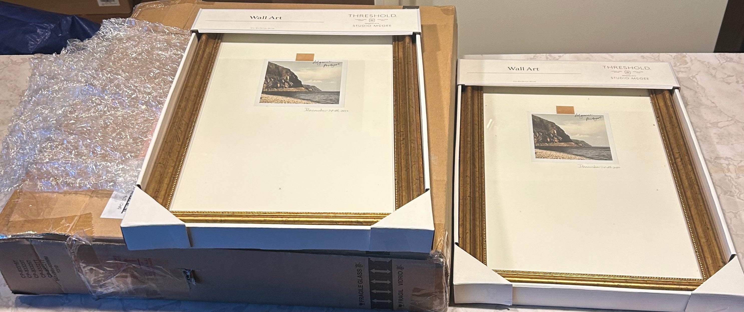This Threshold designed with Studio McGee 12"x18" Travel Photo Gold Framed Wall Art features a gold-toned frame and a coastal photograph labeled "Algarve, Portugal".