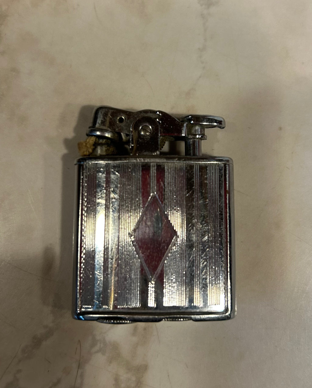 a vintage Ronson De-Light petrol pocket lighter, likely manufactured in the 1930s by the Ronson Art Metal Works company.