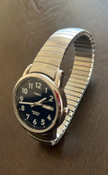 This is a Timex Men's Easy Reader expansion band watch featuring a dark blue dial with clear Arabic numerals.