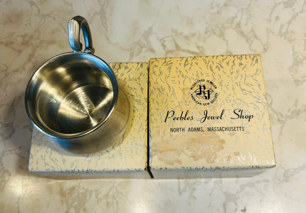 This is a vintage Empire Pewter pot belly baby mug with a polished finish and a stylized handle.